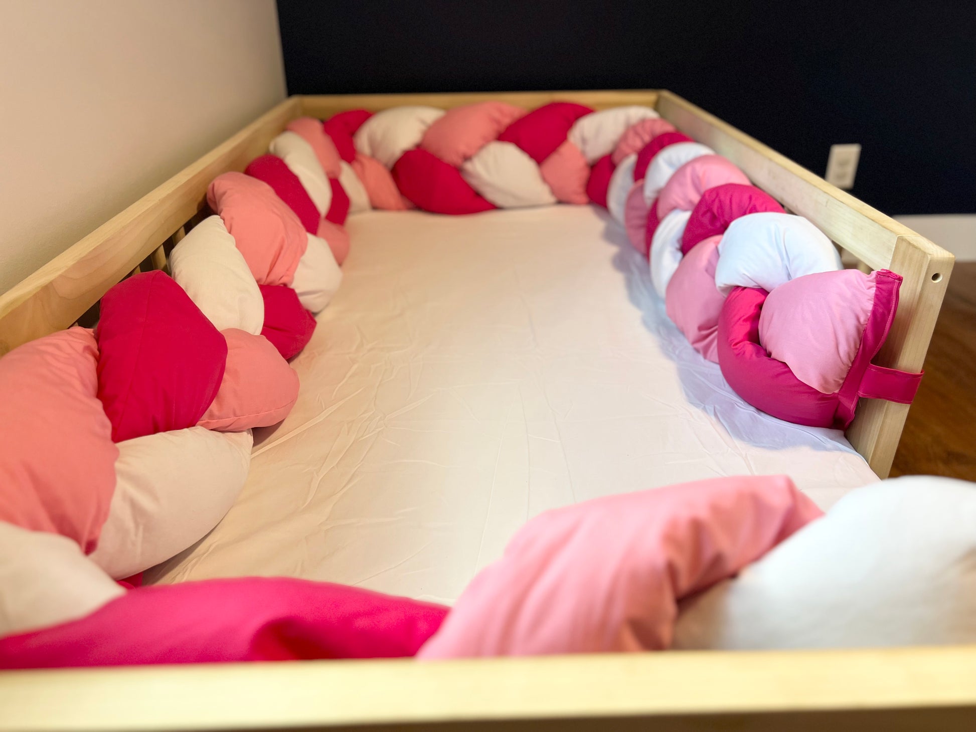 Tri color braided bumper on floor bed.